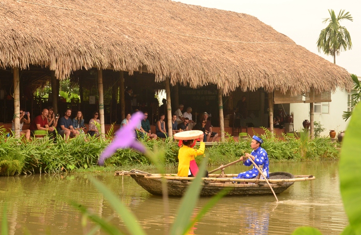 Hát dân ca phục vụ du khách tại khu du lịch làng quê Yên Đức.