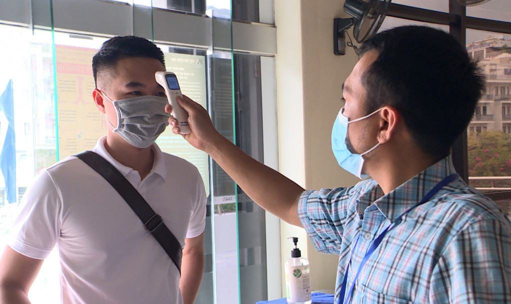 Du khách được đo thân nhiệt trước khi vào tham quan Bảo tàng Quảng Ninh.